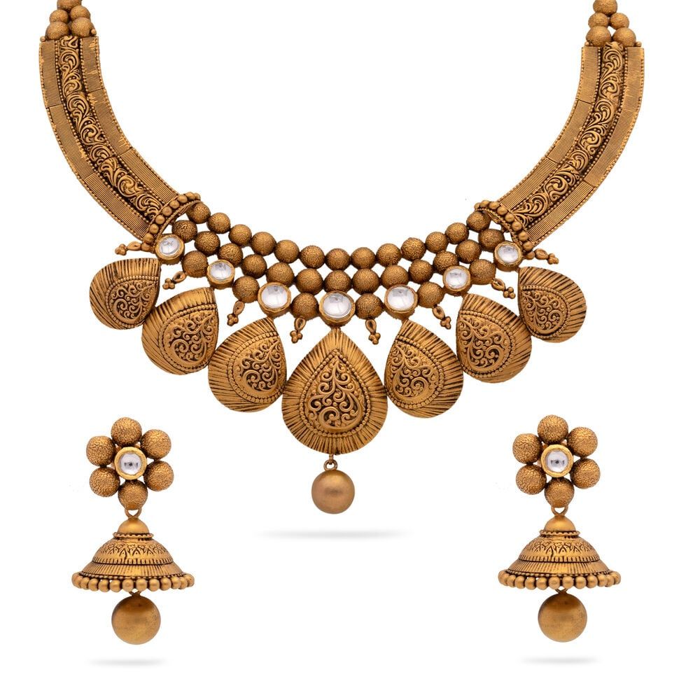 Radiant with intricate artistry, this exquisite set boasts a multi strand necklace and delicate earr